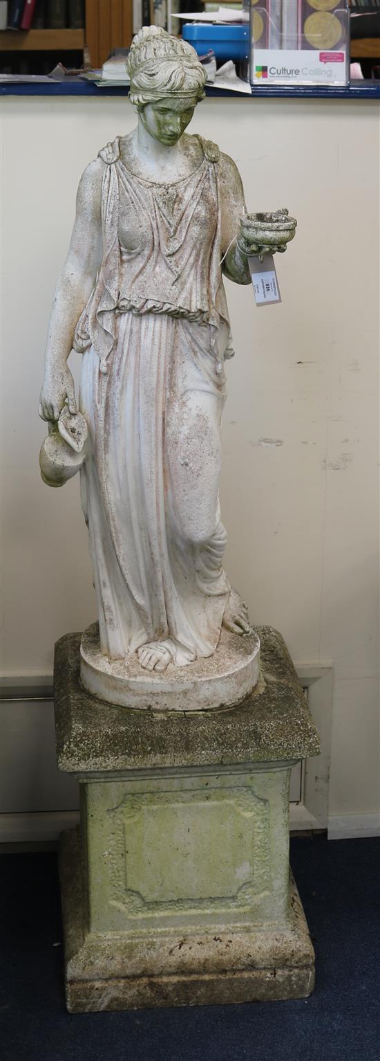 A reconstituted stone garden figure of Hebe holding a bowl and a jug, raised on square plinth W.40cm